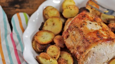 roast pork and sarladaise potatoes in a dish