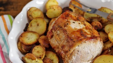 roast pork and sarladaise potatoes in a dish