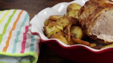 roast pork and sarladaise potatoes in a dish
