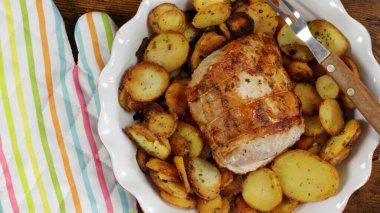 roast pork and sarladaise potatoes in a dish