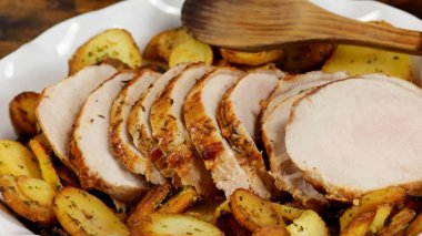 roast pork and sarladaise potatoes in a dish