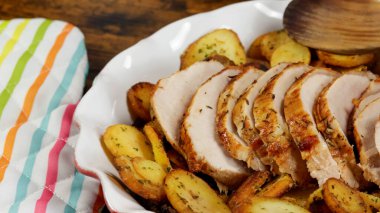roast pork and sarladaise potatoes in a dish