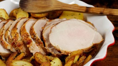 roast pork and sarladaise potatoes in a dish