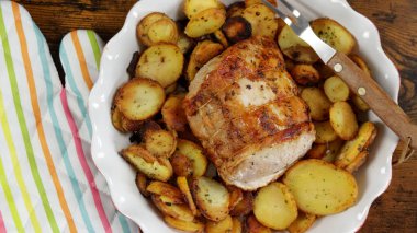 roast pork and sarladaise potatoes in a dish