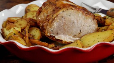 roast pork and sarladaise potatoes in a dish