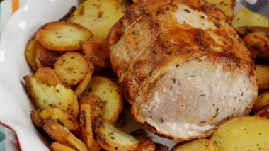 roast pork and sarladaise potatoes in a dish