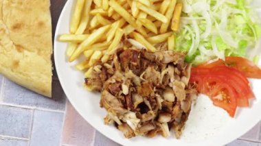 plate of kebab and fries close up