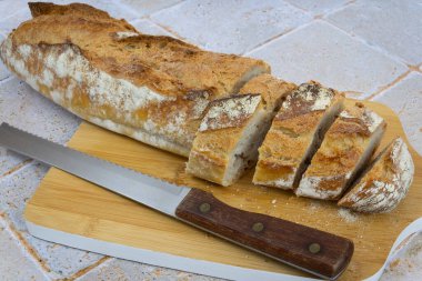 sliced baguette on cutting board