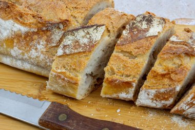 sliced baguette on cutting board