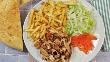 plate of kebab and fries close up