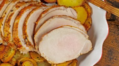 roast pork and sarladaise potatoes in a dish