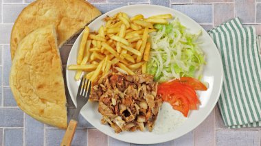 plate of kebab and fries close up