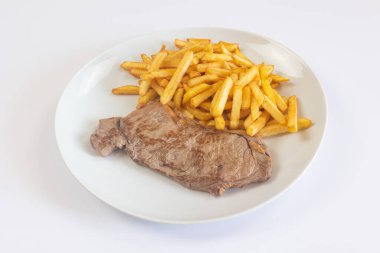 grilled rib eye and fries on a plate