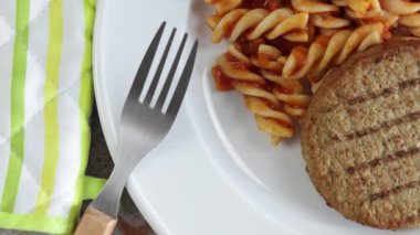 vegetable minced steak and pasta with tomato on a plate