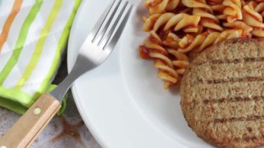 vegetable minced steak and pasta with tomato on a plate