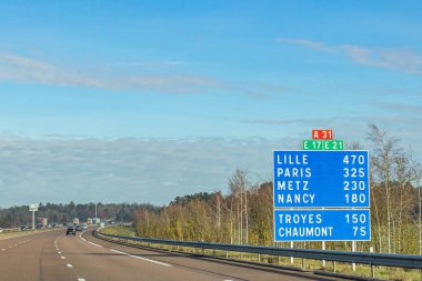 French highway with road sign showing kilometers to next towns clipart