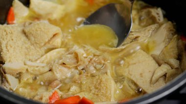tripe, close-up, being cooked in a pan