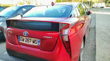 Orange, Vaucluse, France - February 10, 2023 - rear view of a Toyota Prius hybrid brand car parked in a parking lot
