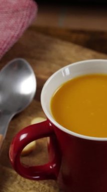 bowl of vegetable soup and croutons, close-up, on a table