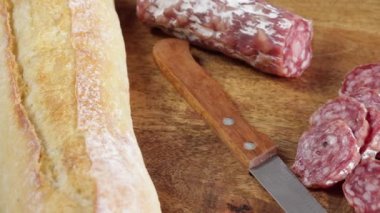 sliced dry sausage close-up on a wooden table