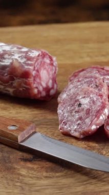 sliced dry sausage close-up on a wooden table