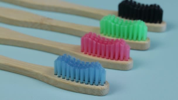 Several Bamboo Wooden Toothbrushes Isolated Blue Background — Stock Video