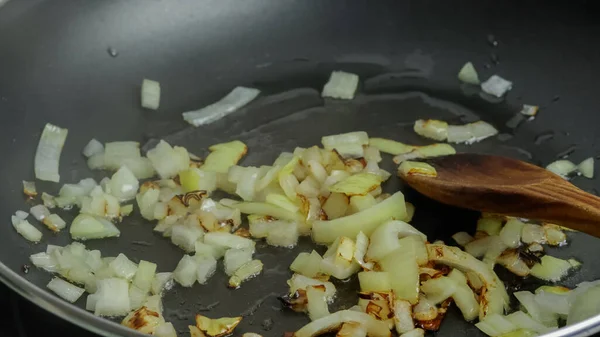 cooking onions in a pan