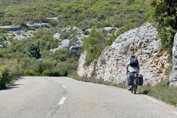 stock image person traveling by bicycle on a small country road in the south of France