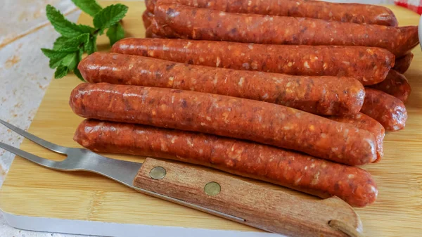 stock image several raw merguez sausages, close-up, on a cutting board