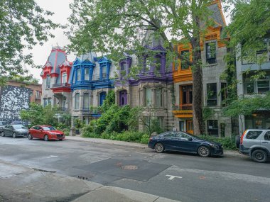 Montreal, Qubec, Canada - 07272023:  Colourful Victorian houses overlooking Place Saint Louis. Montreal, Qubec / Canada. clipart