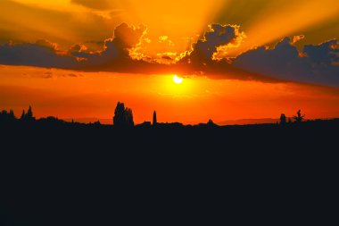 Kırsal bölgede, turuncu gökyüzü ile muhteşem bir gün batımı.