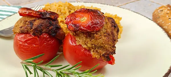 stuffed tomatoes and rice, close-up, on a plate