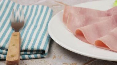 Bir tabakta birkaç dilim jambon.