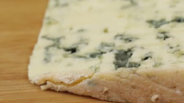 Bir dilim Rokfor peyniri, yakın plan, kesim tahtasında.