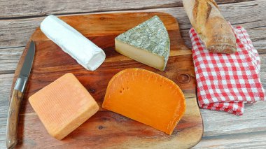 French cheese platter, close-up, on a cutting board clipart
