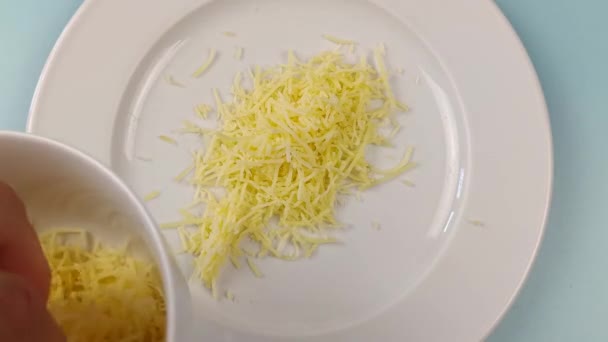 Close Person Hand Filling Plate Grated Cheese — Stock Video