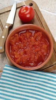 Bir kase ezilmiş domates, yakın plan, kesme tahtasında.