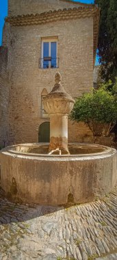 Vaison la Romaine, Vaucluse, France - 04132024: ancient fountain in the old medieval town of Vaison la Romaine (Vaucluse, France) clipart