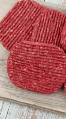 Kesme tahtasında çiğ hamburger bifteği.