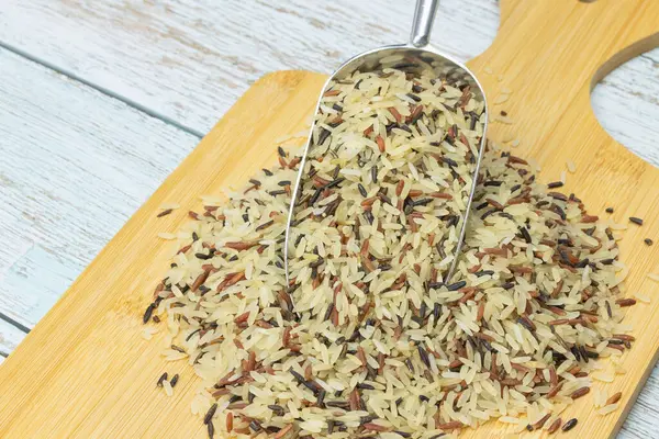 stock image mixture of three raw rices, close-up in a spoon