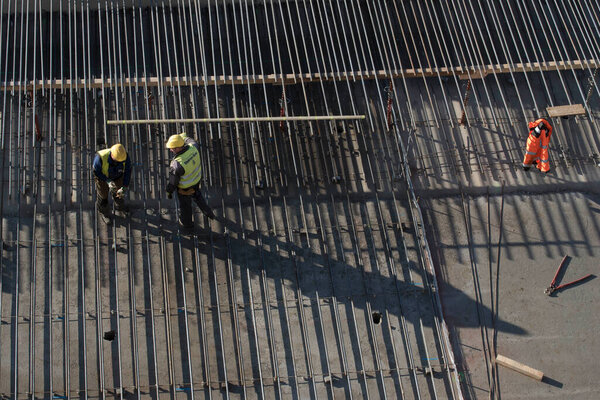 construction worker and reinforced concrete, building at the construction site