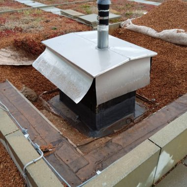 a flat roof on a house, roof top of a building