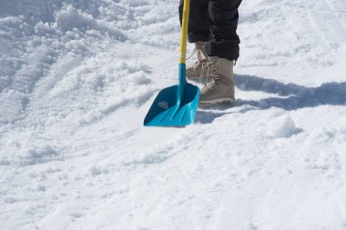 person at snow removal with a snow shovel in winter clipart