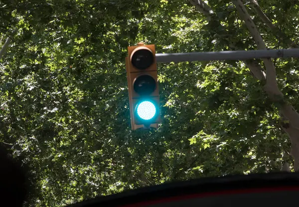 stock image green traffic light signal on the street, symbol for going