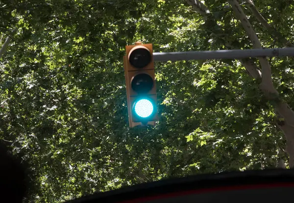 Stock image green traffic light signal on the street, symbol for going