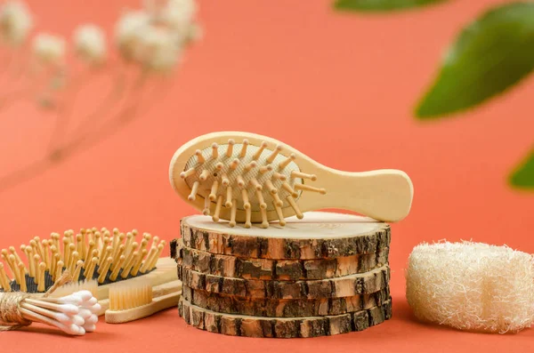 Wooden comb on a natural wooden podium. Photo for advertising a comb or a hairdresser