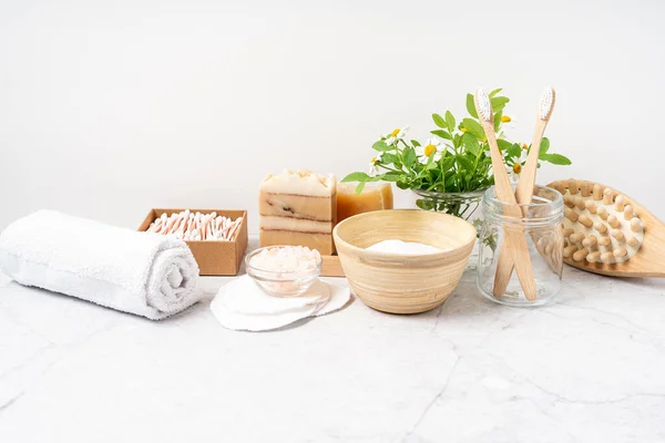 stock image Natural bathroom and home spa tools. Zero waste sustainable lifestyle concept. Bamboo toothbrush, natural soap bar, cotton pads and swabs, homemade DIY beauty products on white background.