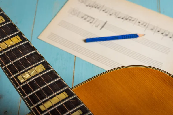 stock image Music recording scene with guitar, music sheet and pencil on wooden table