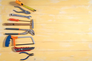 All tools supplies home construction on the yellow wooden background. Building tool repair equipments,copy space,industry engineer tool concept.still-life.