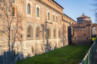 A fragment of the facade of the castle with tower at sunny day in Milan, Italy